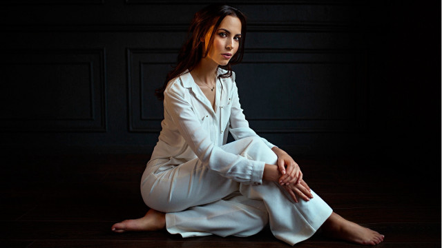 Woman white suit sitting dark #2 free wallpaper - medium preview image