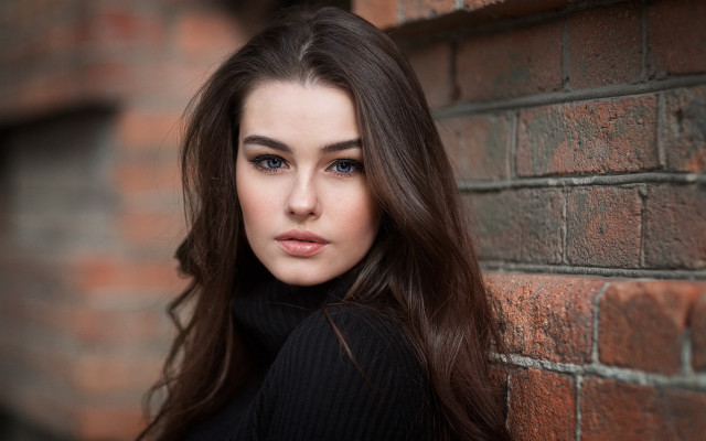 Woman leaning brick wall portrait free wallpaper - medium preview image