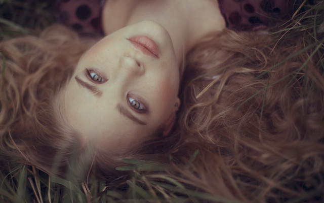 Woman lying grass blowing hair free wallpaper - medium preview image