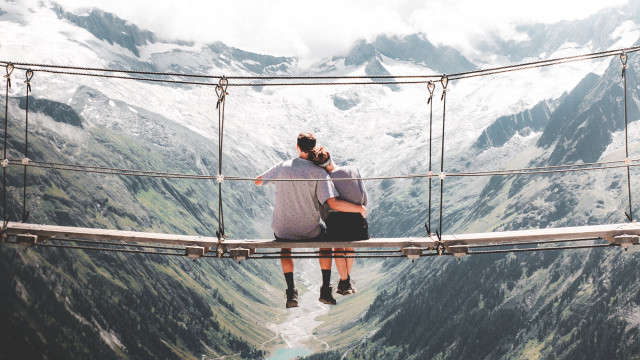 Suspension bridge man mountains hands free wallpaper - medium preview image