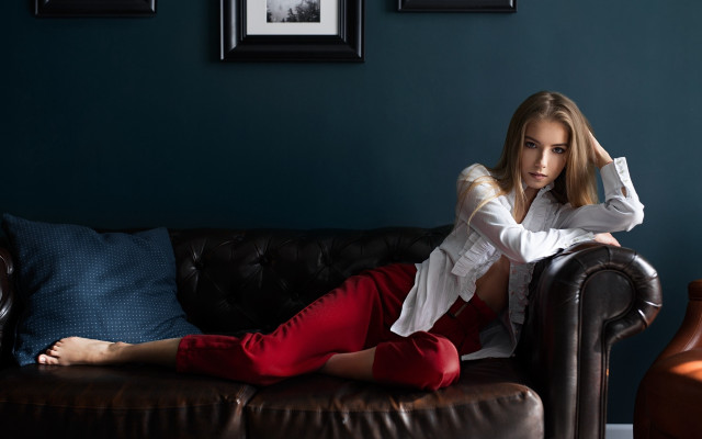 Woman sitting couch blue wall free wallpaper - medium preview image