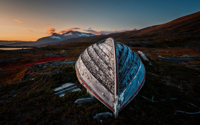 Boat grass mountain sunset sky free wallpaper - medium preview image