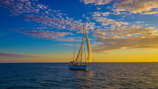 Sailboat ocean sunset clouds people free wallpaper - medium preview image