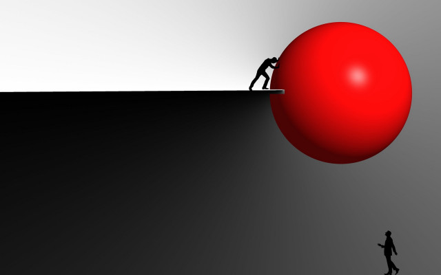 Man pushing red ball up free wallpaper - medium preview image
