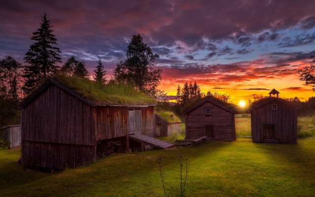 Sunset grassy field wooden buildings free wallpaper - medium preview image