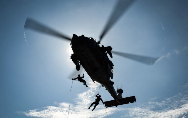 Helicopter hanging men abstract puzzle free wallpaper - medium preview image