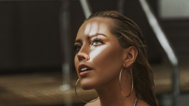 Woman hoop earrings white shirt free wallpaper - medium preview image