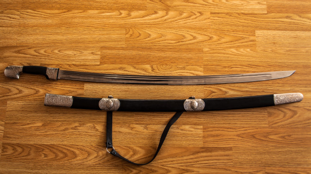 Sword blackleather silverhandle woodenfloor blackstrap free wallpaper - medium preview image