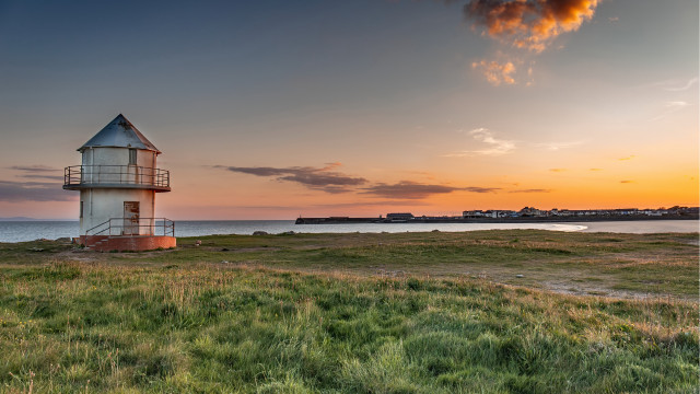 Lighthouse grassy field ocean sunset free wallpaper - medium preview image