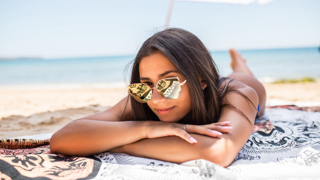 Beach woman sunglasses lying sand free wallpaper - medium preview image