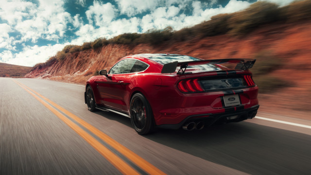 Red mustang mountain road clouds free wallpaper - medium preview image