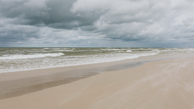 Sandy beach waves cloudy sky free wallpaper - medium preview image