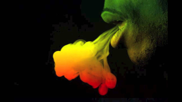 Man blowing colorful smoke fire free wallpaper - medium preview image