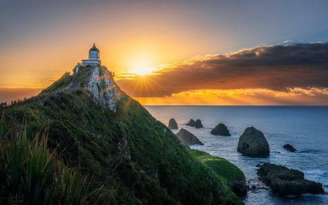 Lighthouse hill sunset ocean rocks free wallpaper - medium preview image
