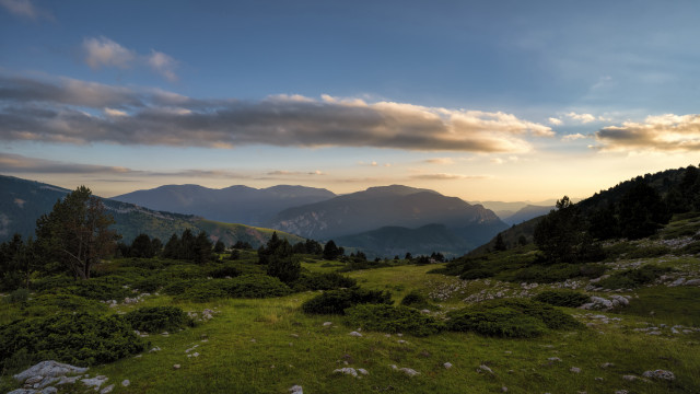 Grassy field mountains sunset clouds #2 free wallpaper - medium preview image