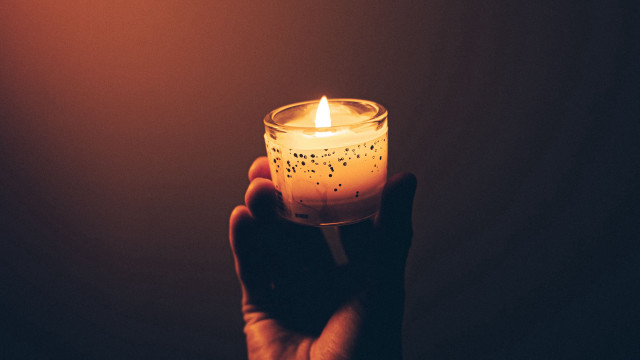 Candle lit symbolism person holding free wallpaper - medium preview image