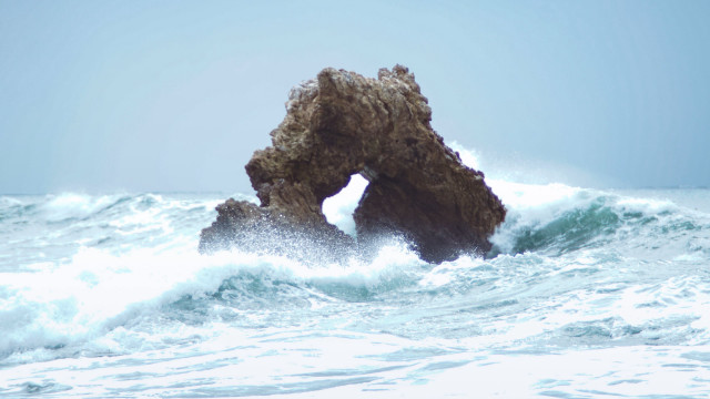 Rock wave surfboard stormy beach free wallpaper - medium preview image