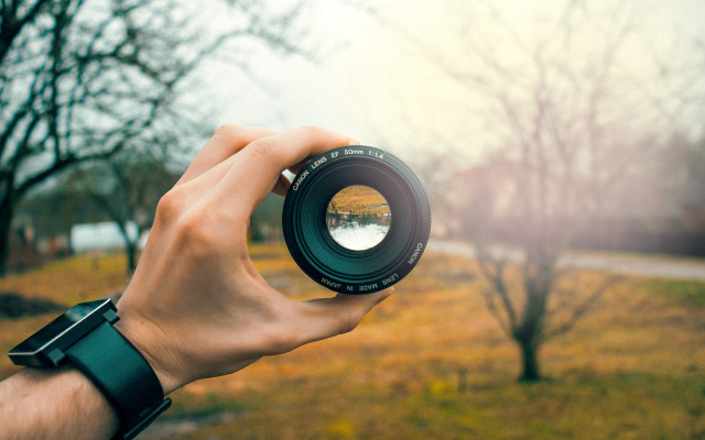 Person holding camera lens blurry #5 free wallpaper - medium preview image