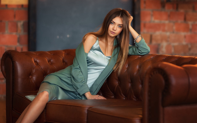 Woman green dress couch brick #2 free wallpaper - medium preview image