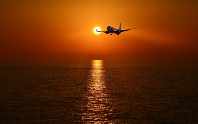 Plane ocean sunset sky sun free wallpaper - medium preview image
