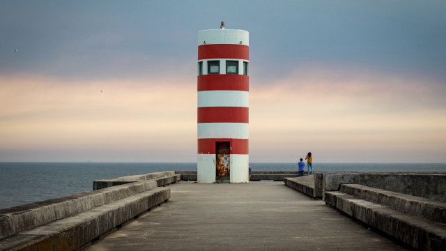 Lighthouse pier ocean solo cloudy free wallpaper - medium preview image