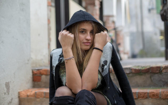 Woman sitting hooded portrait blurry free wallpaper - medium preview image
