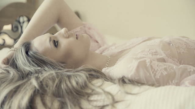 Woman laying bed hair blowing free wallpaper - medium preview image