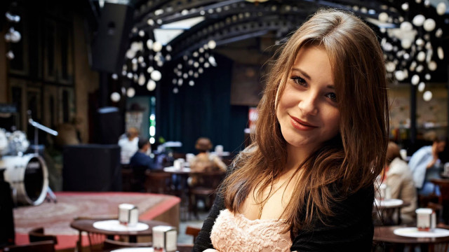Smiling woman cafe bokeh portrait free wallpaper - medium preview image
