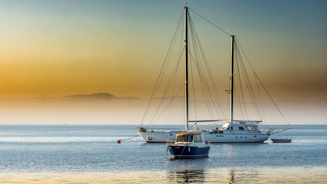Sailboat mountain fog sunset tranquil free wallpaper - medium preview image