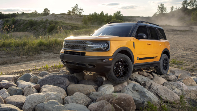 Yellow truck rocky forest hill free wallpaper - medium preview image