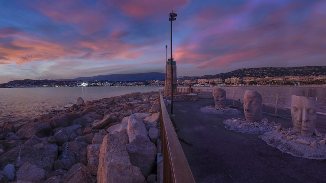 Sunset beach statues cityscape surrealist free wallpaper - medium preview image