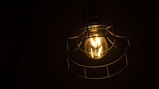 Lit bulb wire cage dark free wallpaper - medium preview image