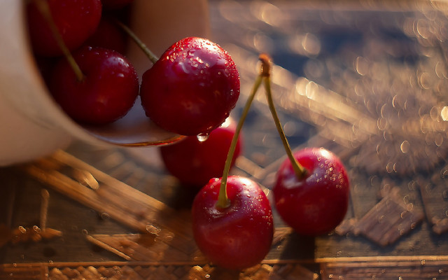 Cherry hand macro photorealism blurry free wallpaper - medium preview image