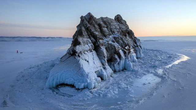 Frozen lake rock person distant free wallpaper - medium preview image