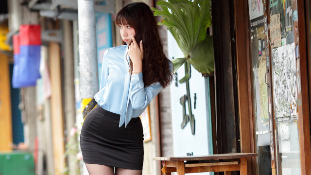 Woman skirt cellphone storefront bench free wallpaper - medium preview image