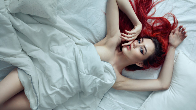 Red haired woman on bed free wallpaper - medium preview image