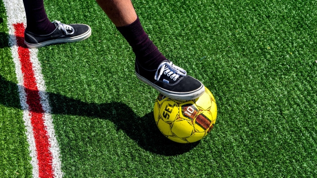 Athletic person standing on soccer free wallpaper - medium preview image