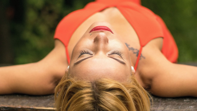 Woman red top laying on free wallpaper - medium preview image