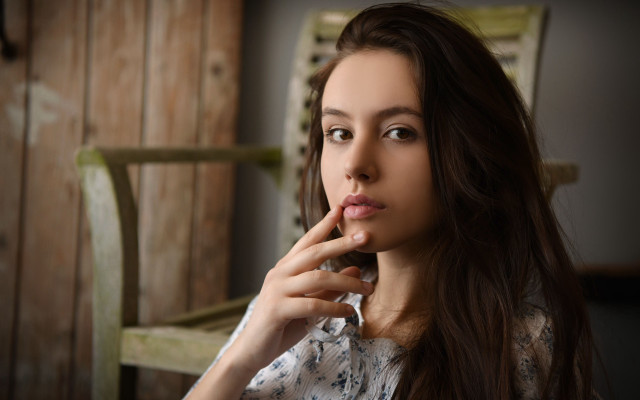 Woman sitting finger mouth portrait free wallpaper - medium preview image
