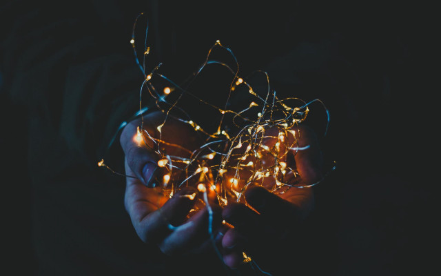 Glowing person holding lights dark free wallpaper - medium preview image