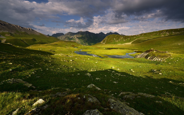 Grassy lake mountains clouds cityscape free wallpaper - medium preview image
