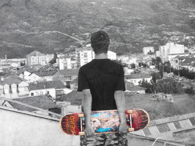Man skateboard rooftop city view free wallpaper - medium preview image
