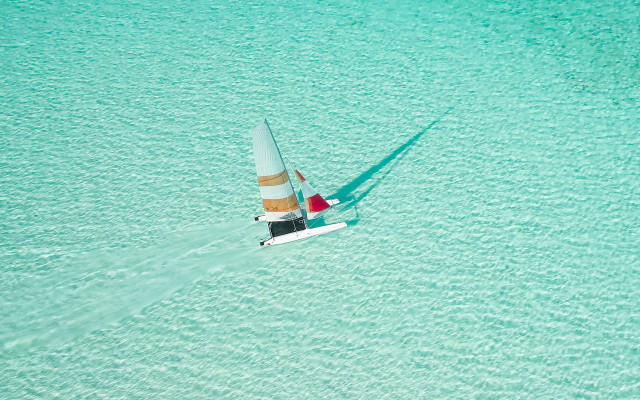 Sailboat blue ocean shadow hyperrealistic free wallpaper - medium preview image