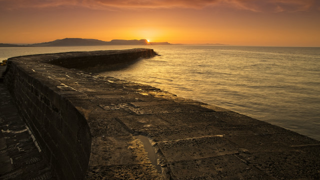 Sunset ocean stone wall island free wallpaper - medium preview image