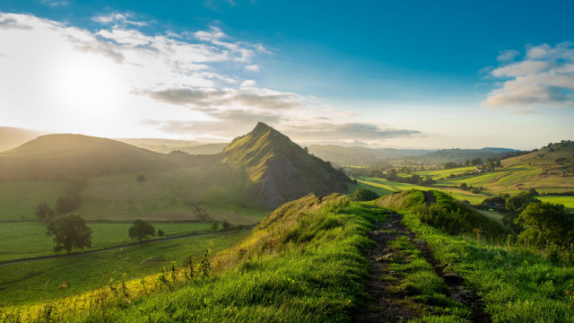 Grassy field path mountain sun free wallpaper - medium preview image