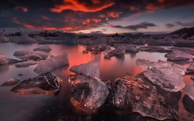 Sunset water rocks clouds cityscape free wallpaper - medium preview image