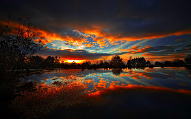 Sunset reflecting lake trees clouds free wallpaper - medium preview image