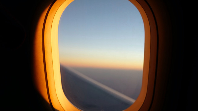 Airplane wing window sunset liminal free wallpaper - medium preview image