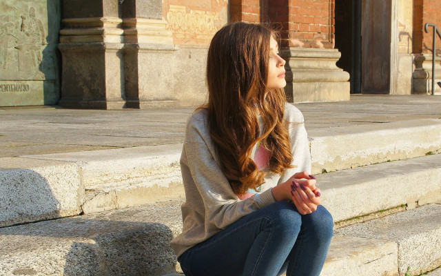 Woman praying steps building cityscape free wallpaper - medium preview image