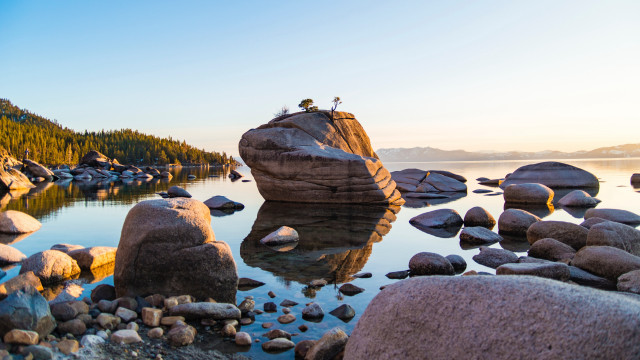 Person lake rocks trees mountain free wallpaper - medium preview image